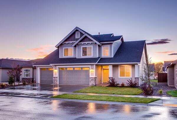 A house with a driveway and garage in front of it.