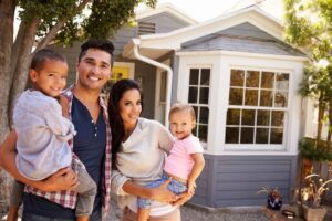 A family standing in front of their home.