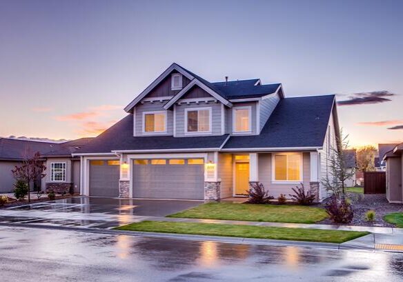 A house with a driveway and garage in front of it.