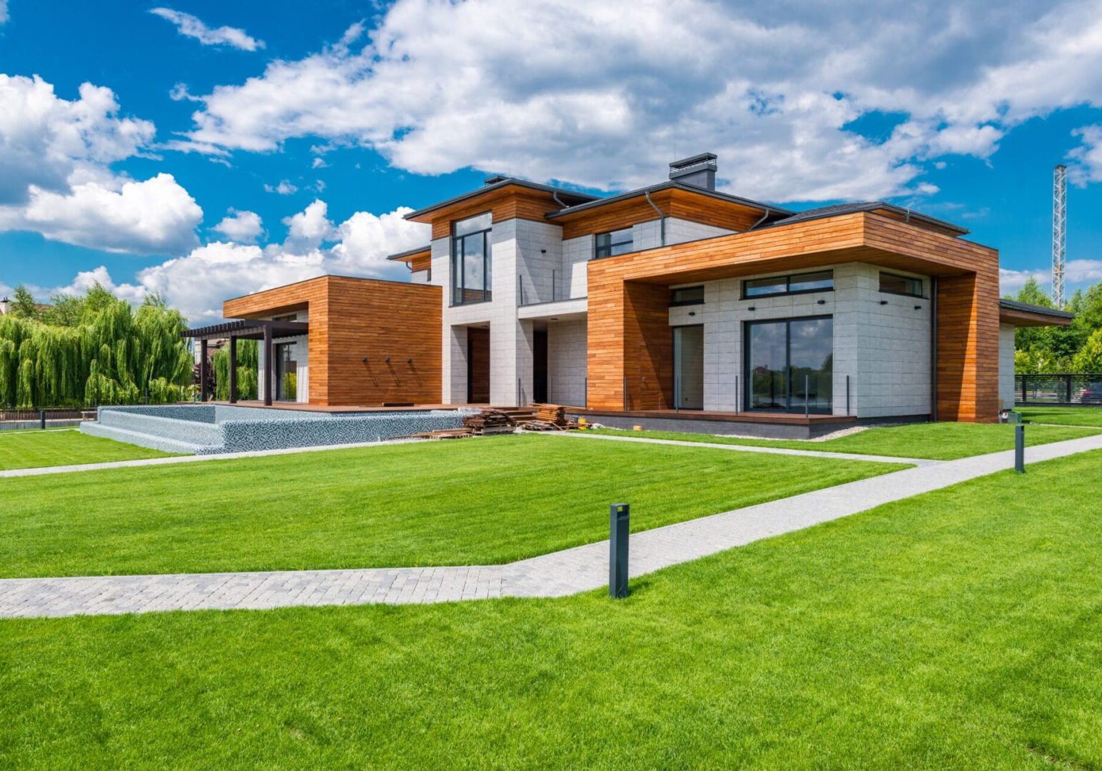 A large house with a nice lawn and sky background